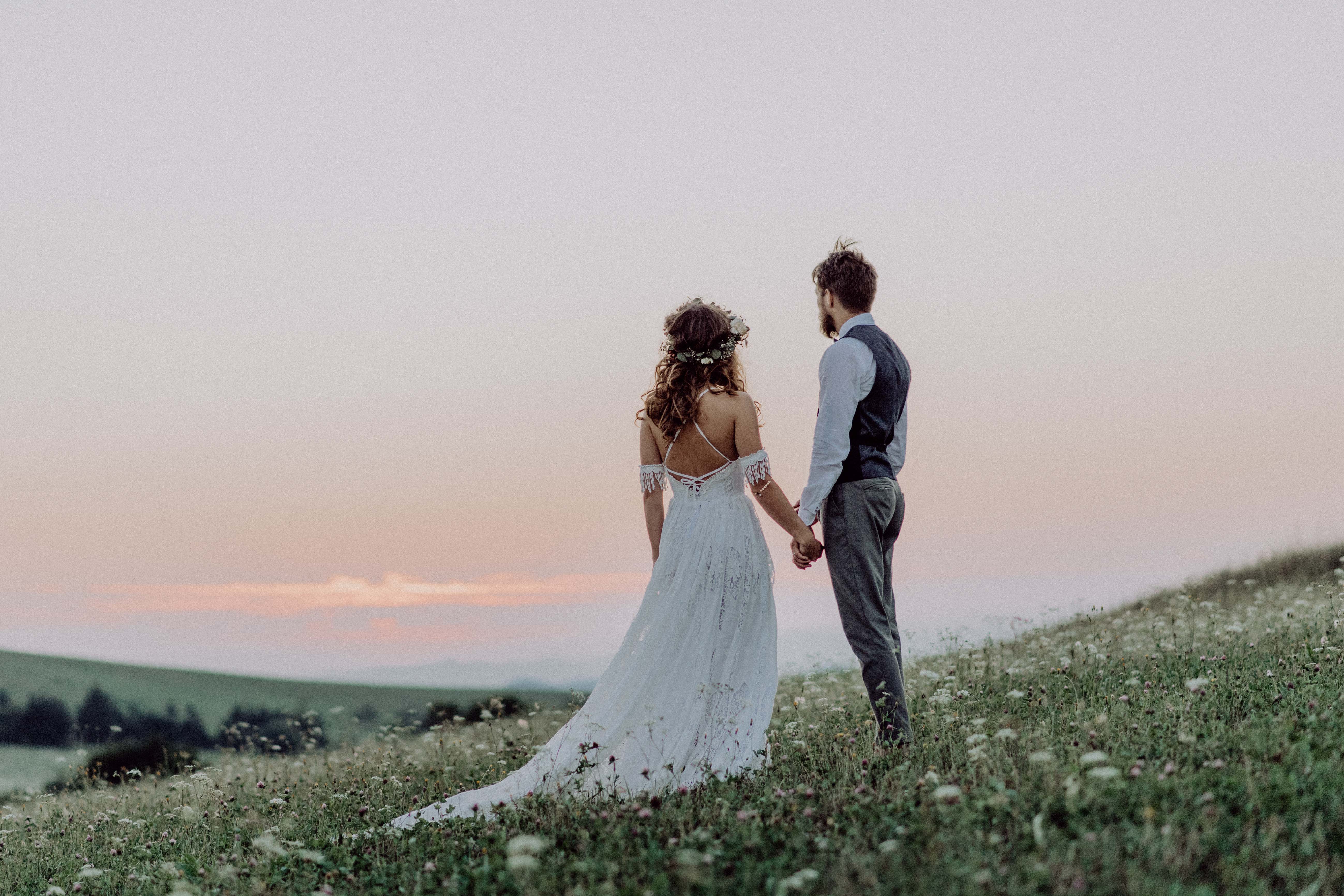 Beautiful bride and groom at sunset in green nature.